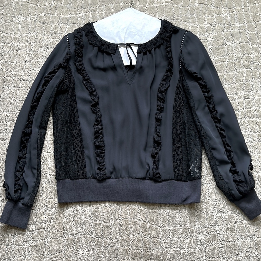 Rebecca Minkoff black blouse w v-neck key hole detailing. Ruffles w black lace